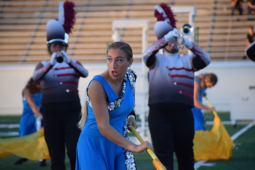 Braden River sophomore Julia Glaser moves between band members while twirling her flag in unison with the rest of the color guard.