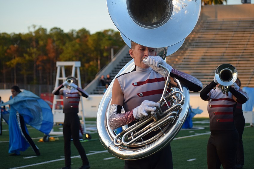 Braden River's Connor Snead marches to the front of the field with other tuba players as part of the band's formations.