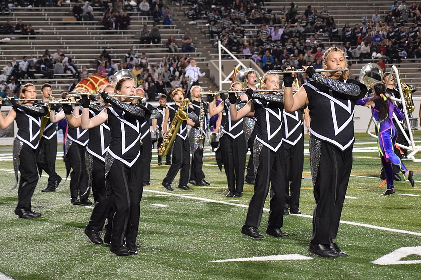 Lakewood Ranch Marching Mustangs try to keep a straight formation during their performance.