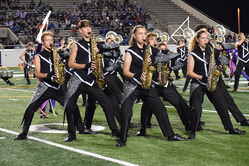 Marching Mustangs members create a group formation.