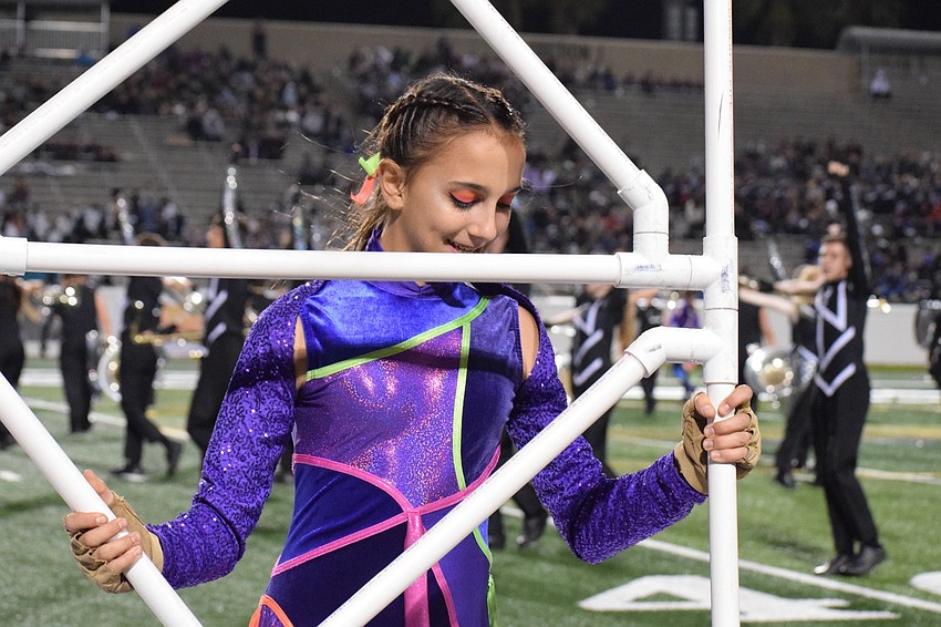Eighth grader Mia Mainella secures a prop in place.