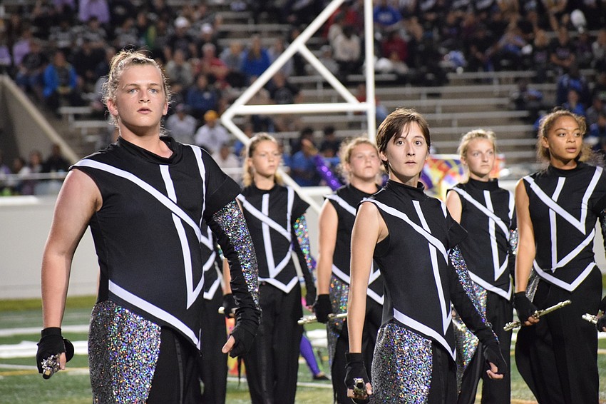 Brian McCoy and Olivia Miller lead a formation.