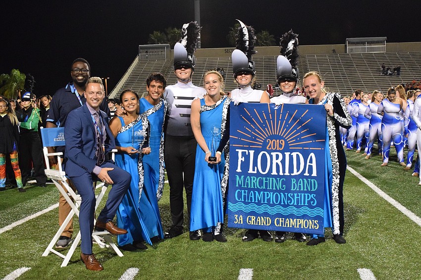 Braden River director Jeramiah Bowman and Marching Band of Pirates leadership commemorate their first place win.