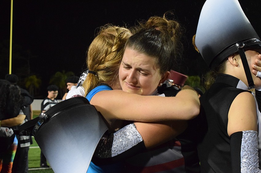 Braden River seniors Sianna Harris and Jessica Baus embrace after the band was announced as the first place winners in the 3A division.
