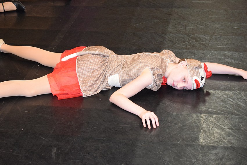 Brooke Palmtag spreads out on the floor as he plays a sock monkey doll.