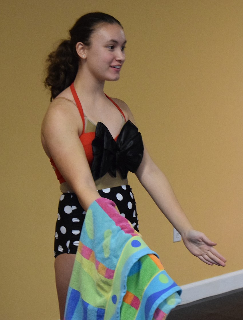 Julia Vendramini gets into the act as a beach Barbie doll.