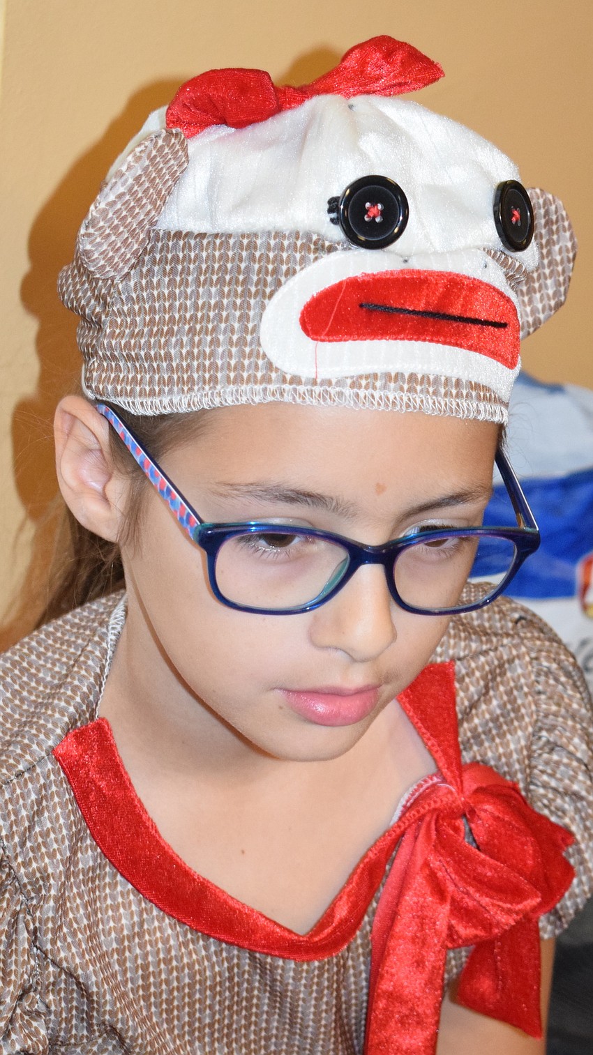 Lara Zoppe waits for her turn to act as a sock monkey doll.