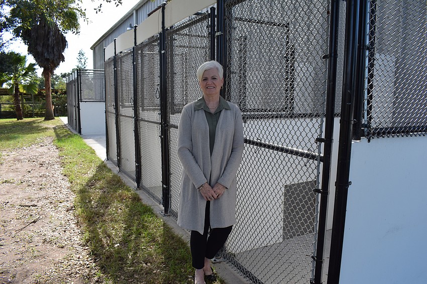 Deanna Murchie stands next to an outdoor section of the new kennels.