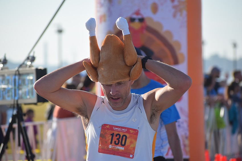 Sarasota's Keith Page might have not won the Florida Turkey Trot but he was the first one to finish wearing a turkey on his head. 
