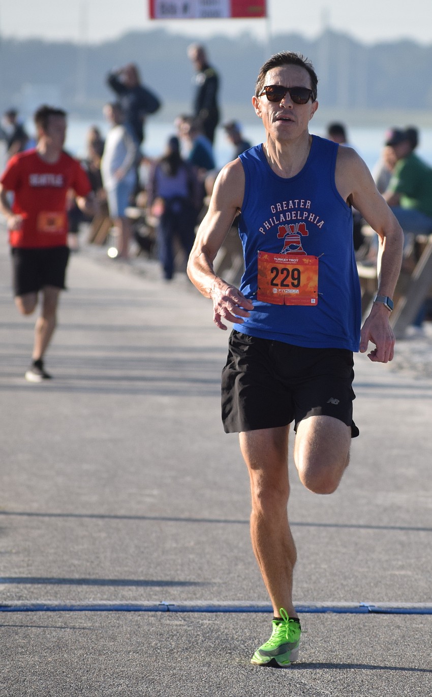 Mike Padilla of Phoenixville, Pa., finishes his victory in the Florida Turkey Trot 5K. He ran 16:37.