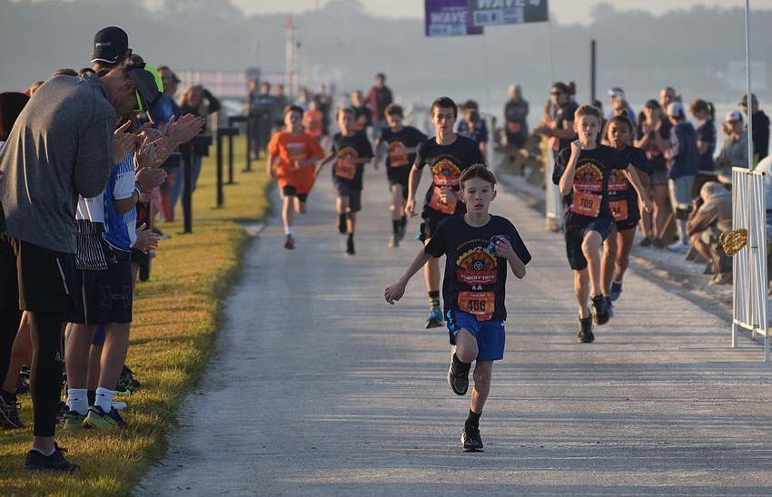 Cameron Laxton of Rolesville, N.C., in town to visit relatives, wins the final kids race.