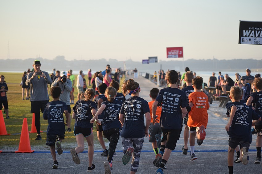 The final kids dash kicks off as runners head out to run along the lake at Nathan Benderson Park.