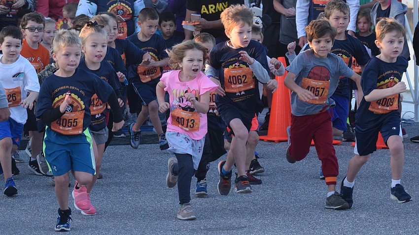 Children break away from the starting line in a kids dash.