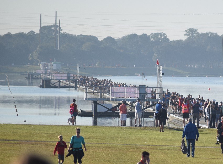 Runners stream across a bridge toward the finish line.