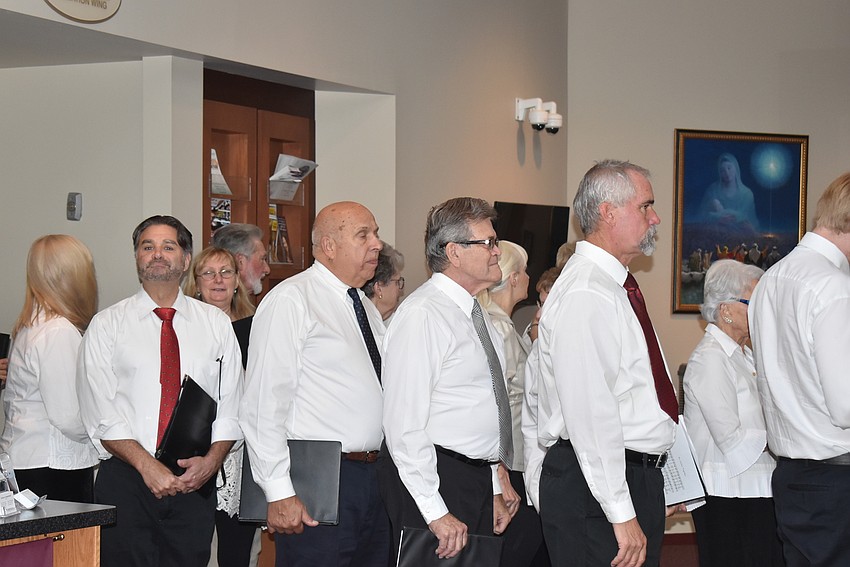 The choir from multiple churches heads into the church.