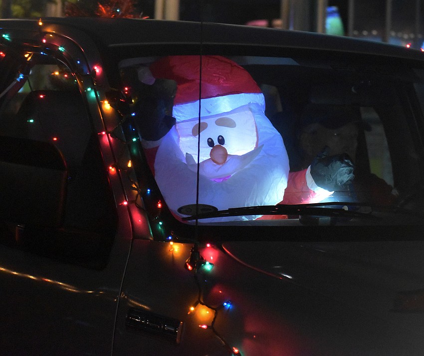 An inflatable Santa rides in one of the floats.