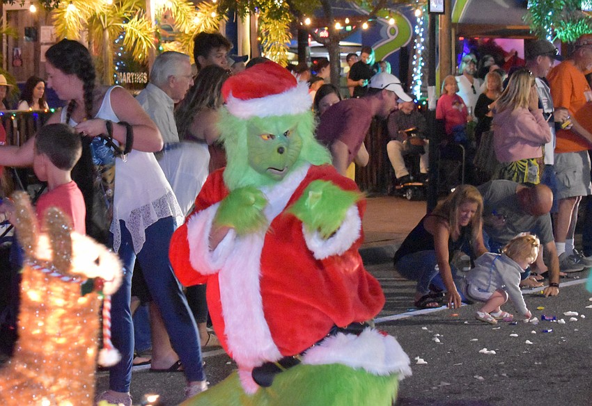 One of the three Grinches interacts with the crowd.