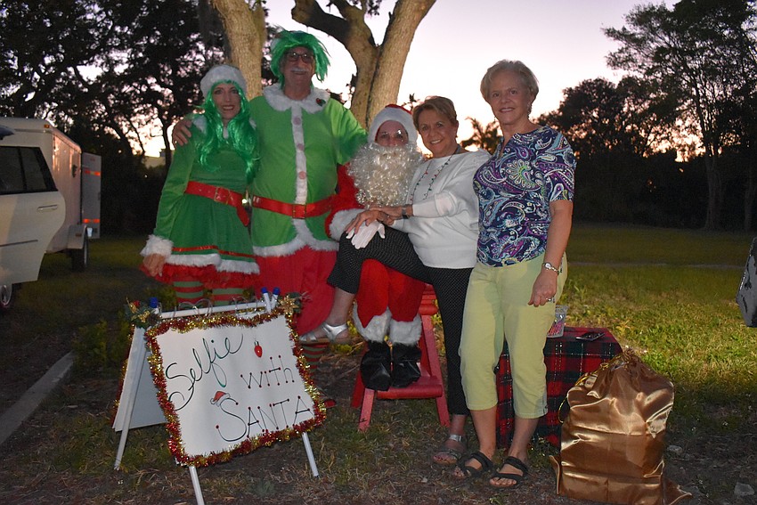Elves Henriette Van Eck and Martin Poretsky and Santa Claus Nancy Rozance with Mary Harper and Carol Peschel.