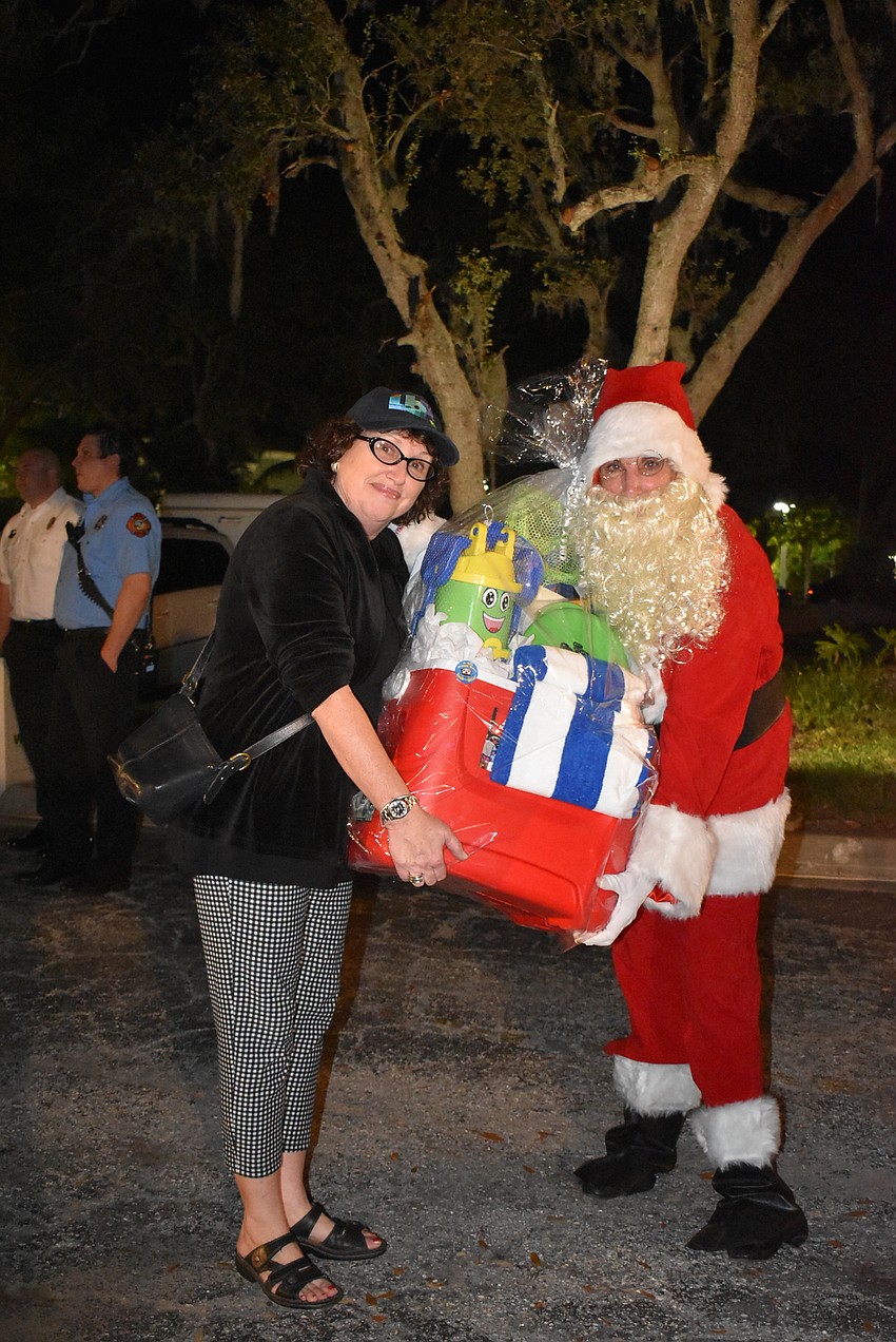 Linn Torres and Nancy Rozance, standing in as Santa.