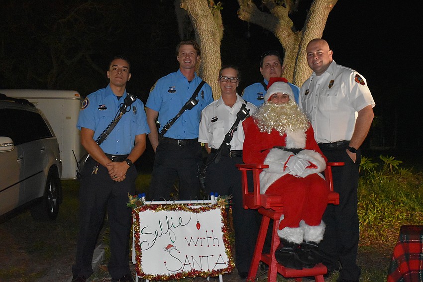 Josh Falcon, Jamison Urch, Kerri Brooks, Jason Berzowski and Bryan Carr pose with Santa.