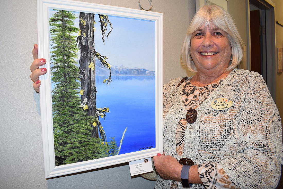Lakewood Ranch&#39;s Gloria Kaminsky shows off her oil on canvas painting of Crater Lake. She said she has been painting 10 years and is self taught.