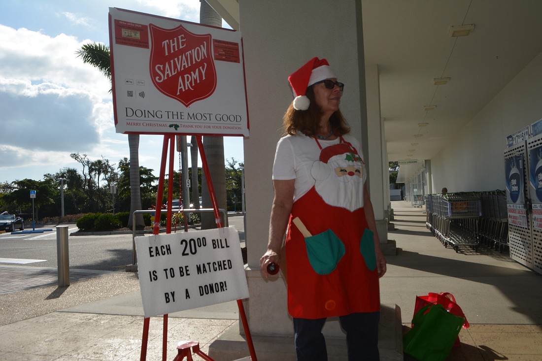 Beth Fusco rings the Salvation Army bell, ready to greet customers as they walk out of Publix.