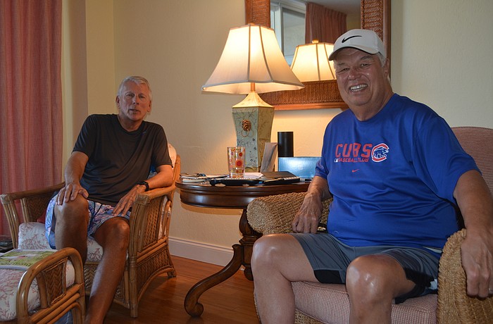 Ed Janka (right) and Bob Brown sit in the living room of Janka's apartment. They did most of their work for the book in this building, where Brown also owns an apartment.