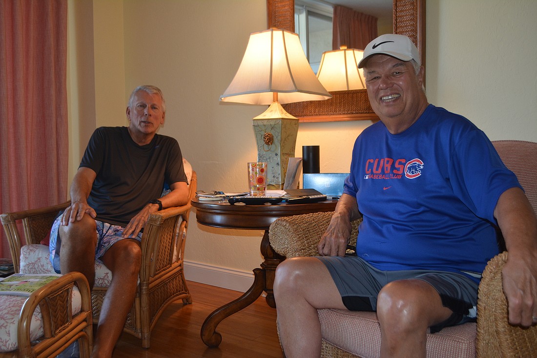 Ed Janka (right) and Bob Brown sit in the living room of Janka&#39;s apartment. They did most of their work for the book in this building, where Brown also owns an apartment.