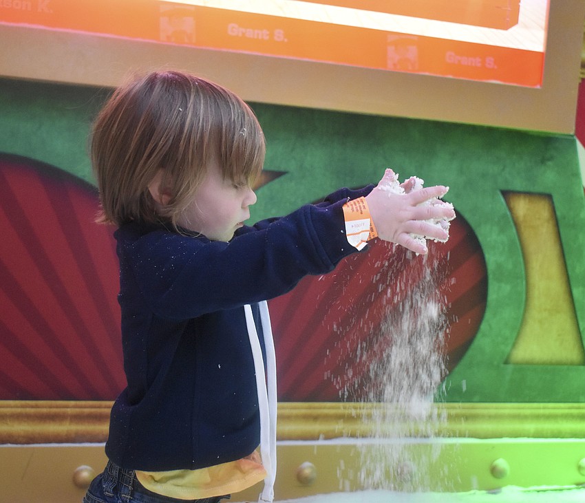 Grant Stickley, 2,  plays in the fake snow.