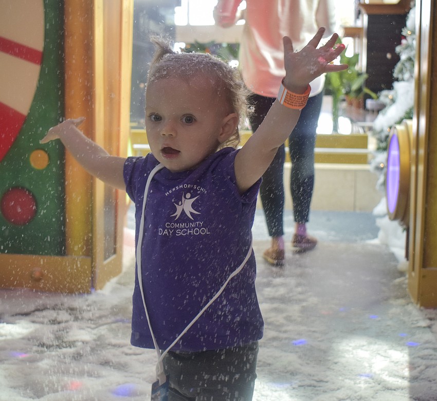 Jay Sweeting, 2, plays in the fake snow.