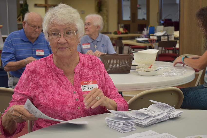 Susan Stuckert folds Messages of Hope.