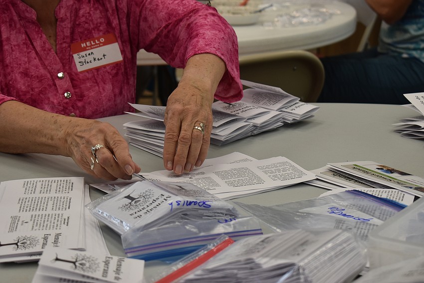 Susan Stuckert folds Messages of Hope.