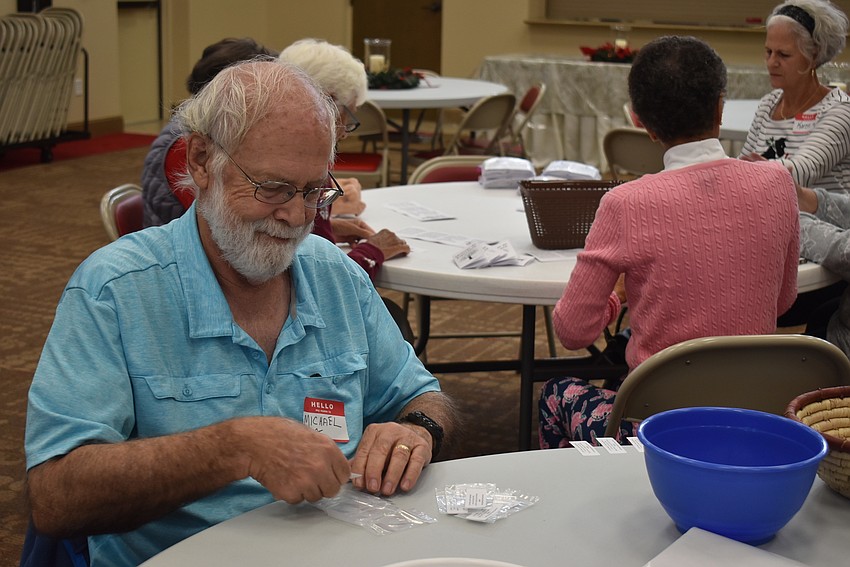 Michael McLaughlin fills a seed packet.