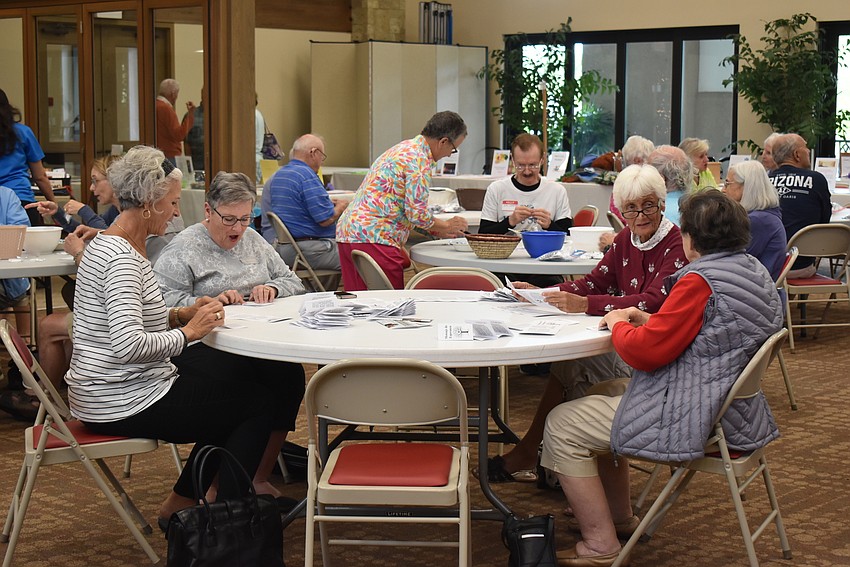 Volunteers chatted and packed seeds.