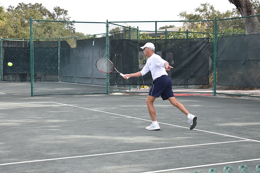 Jim Lazenby returns a serve.