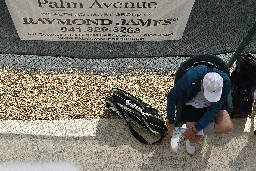 Tom Lightvoet adjusts his socks before his match.