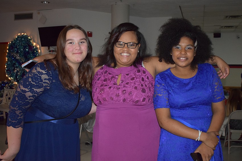Eighth-graders Elizabeth Lambert, Taniya Young and Shanti Villalobos love the dancing, music, food and decorations at the Snowcoming Dance.