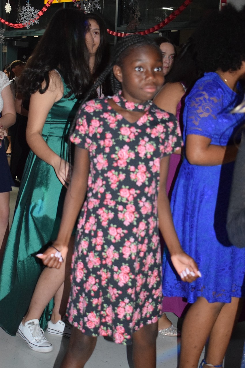 Donesha Reed, a sixth-grader, dances with dozens of other students during the 