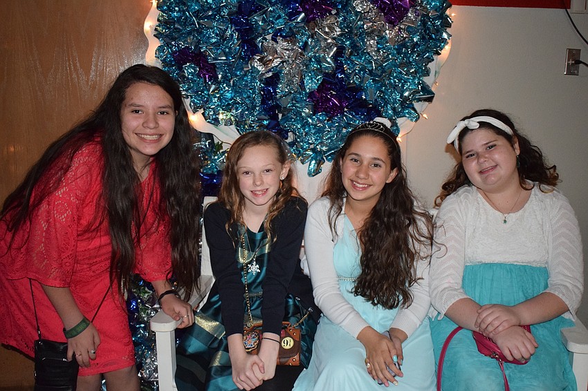 Alanna Hall, Lily Harris, Giovanna Mendes and Layla Robertson, all sixth-graders, take a break from dancing. The group of friends took a selfie to commemorate their time at the dance.