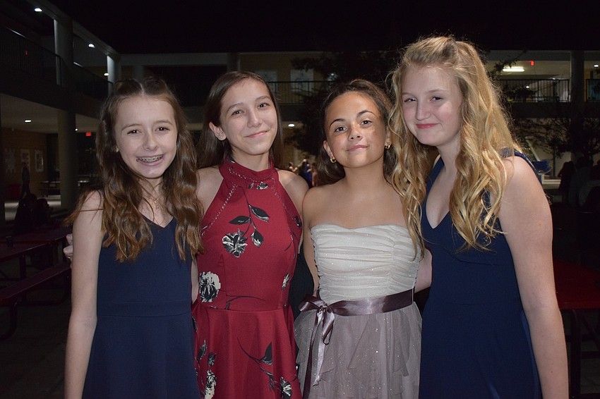 Kayden Withers, Liliana Vazquez, Addison Kolbe and Hailey Williams, all eighth-graders, spend time with each other during the Snowcoming Dance.