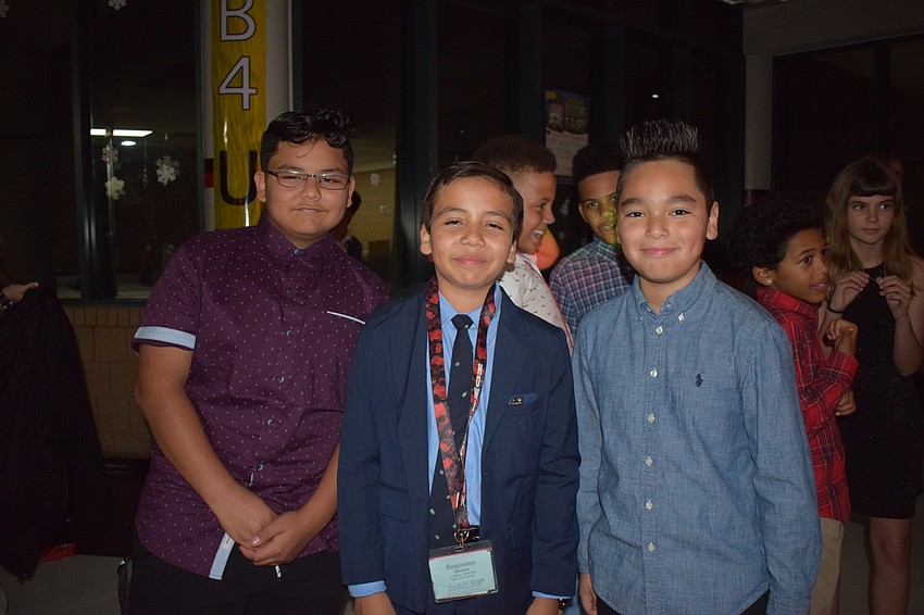Luis Palafox, Kyle Page and Isai Palacios-Alejandre, sixth-graders, dance together.