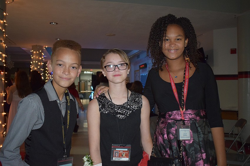 Eli Bazo, Sydney Sumner and Airiona Rodgers, sixth-graders, like the music at the dance.