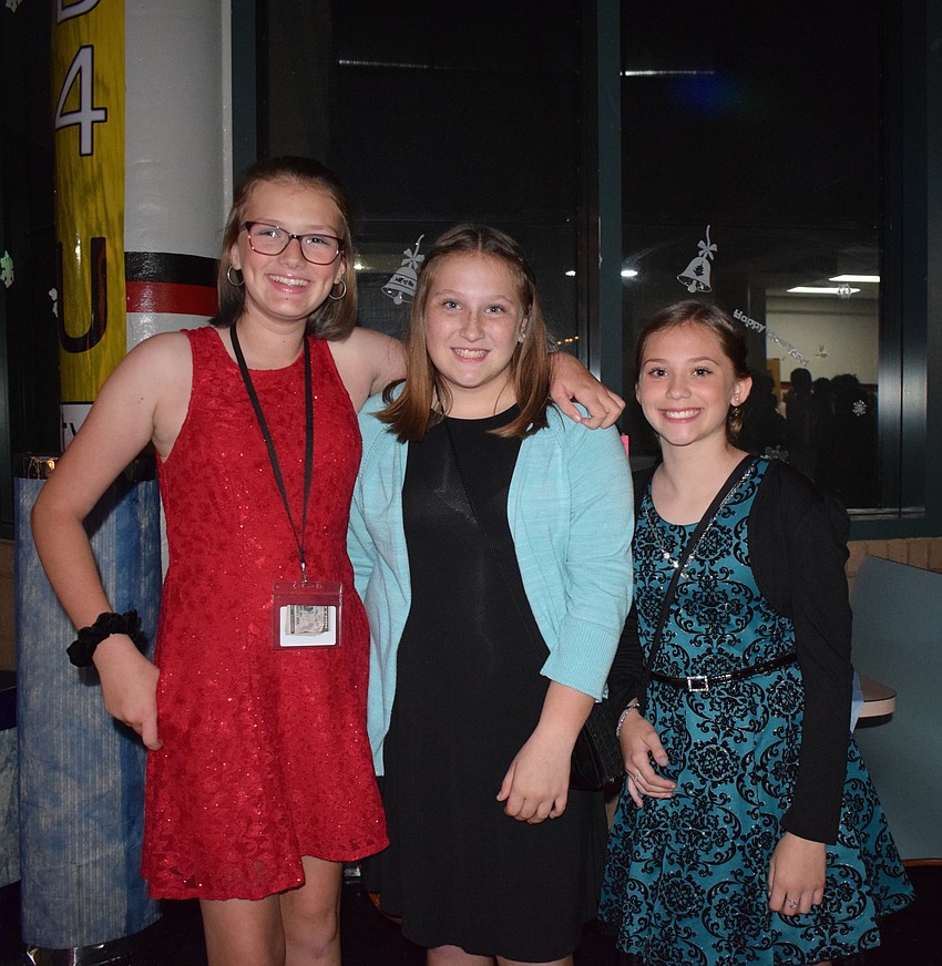 Annabella Stevens, Abbi Barker and Lindsay Austen, seventh-graders, enjoy spending time with each other during the dance.