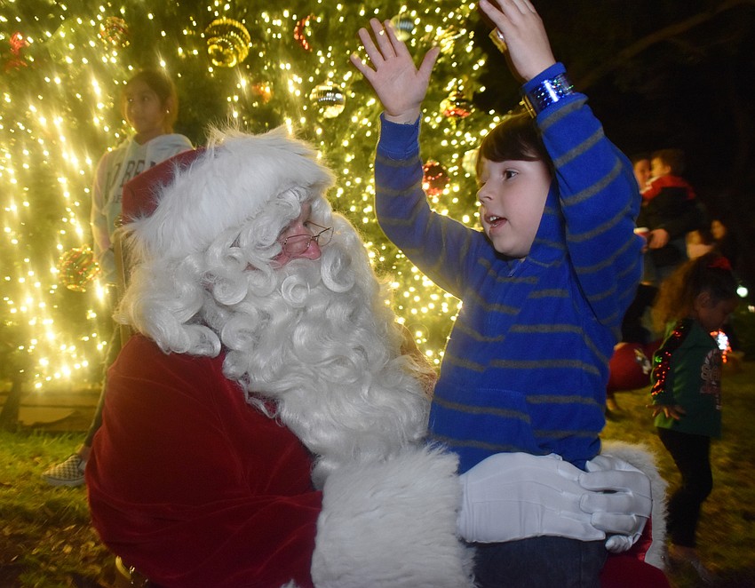Tyler Schoelles, 5, tells Santa that he wants a Hot Wheels set for Christmas.