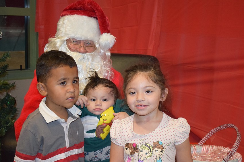 Lakewood Ranch's Benjamin Bautista, and Xavier and Geselle Villacorta take a photo with Santa.
