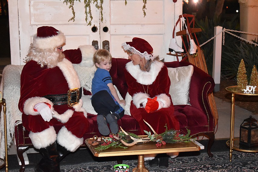 Steve Pruitt hangs out with Santa and Mrs. Claus.