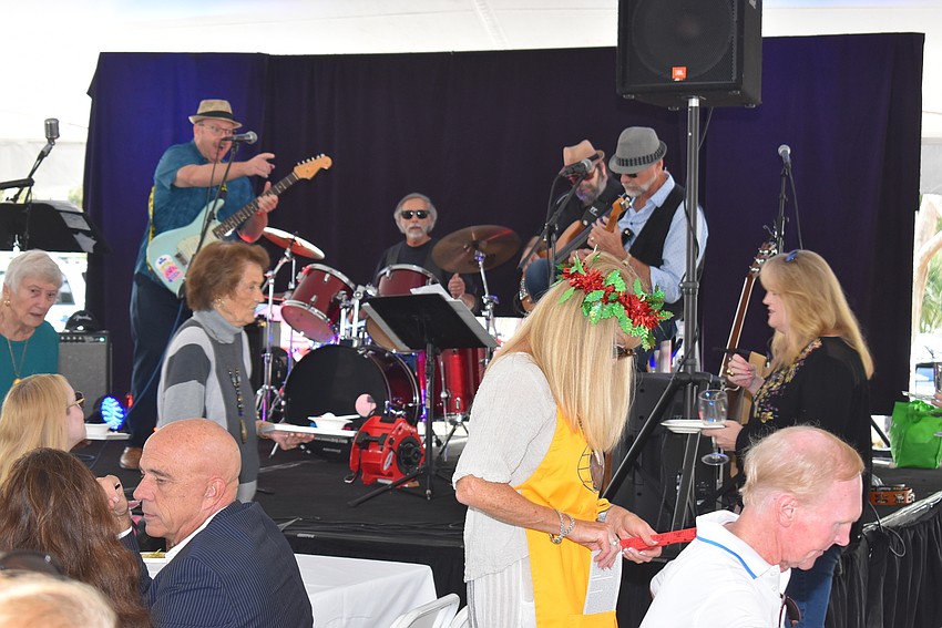 Kiwanis members went around selling raffle tickets while live music played.