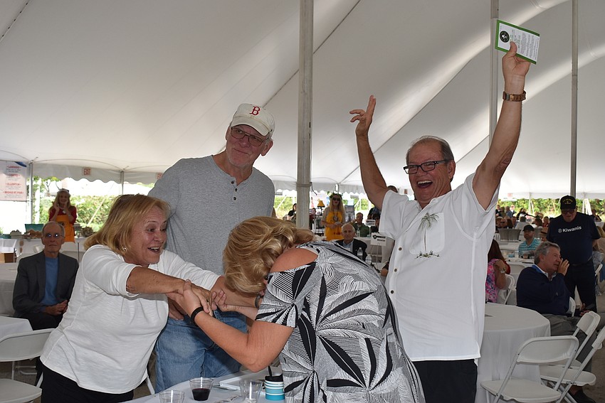 John and Karen Henry celebrate their win of the $20,000 raffle prize with Bill and Susanne Weber.