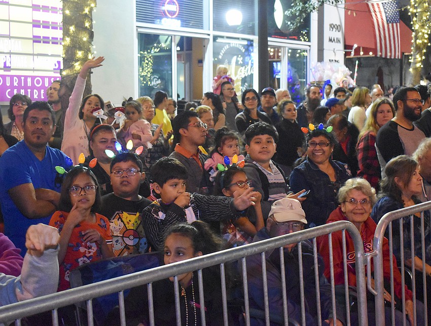 The crowd watches as the parade goes by.