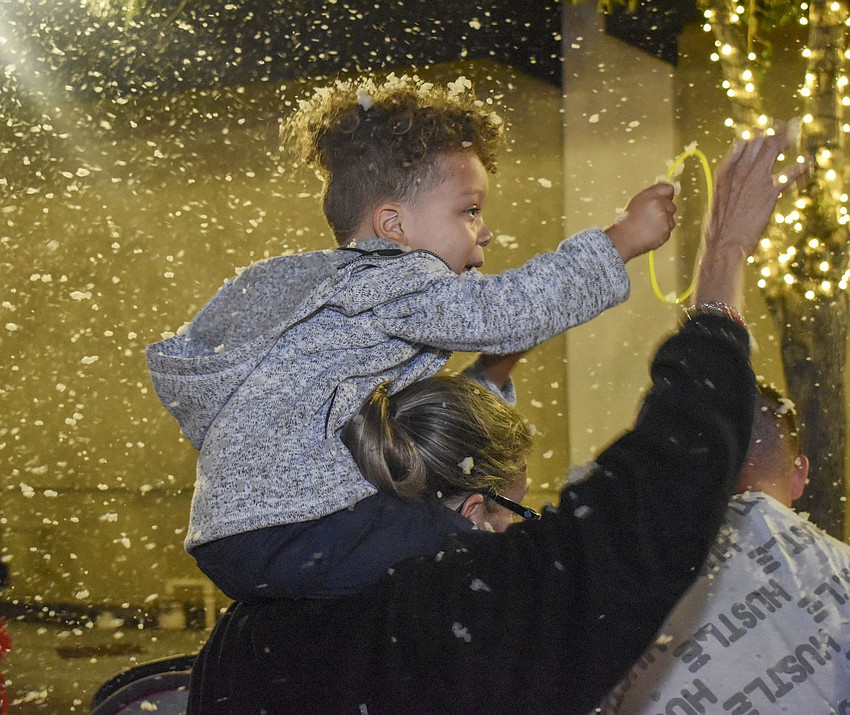 Ashton Randall, 3, reaches for the snow.
